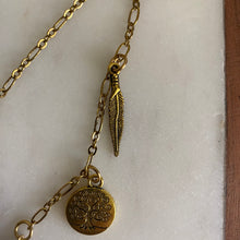 Load image into Gallery viewer, Close-up of Fauna cruelty free hair clip 2 brass charms (a tree of life and a feather).