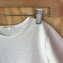Load image into Gallery viewer, Close-up of FAUNA Kids Off White Hemp tee featuring a curved hem, round neck, and lots of love to Mother Earth.
