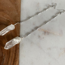 Load image into Gallery viewer, Fauna healing crystals as jewelry with these beautiful long shoulder duster earrings. Made from a stainless steel chain with a White Quartz crystal at the end, connected to stainless steel french hook ear wires.