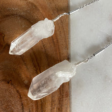Load image into Gallery viewer, Fauna healing crystals as jewelry with these beautiful long shoulder duster earrings. Made from a stainless steel chain with a White Quartz crystal at the end, connected to stainless steel french hook ear wires.