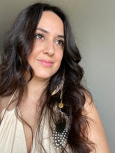 Load image into Gallery viewer, Woman wearing a Fauna eucalyptus and organic cotton maxi dress and cruelty free hair clip connecting 2 brass chains with 3 types of ethically sourced chicken feathers on each end. Also features 2 brass charms (a tree of life and a feather).
