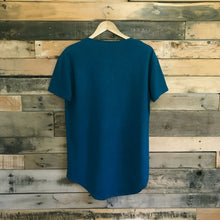 Load image into Gallery viewer, Back of FAUNA blue hemp and organic cotton mens tee featuring a raw edged pocket, curved hem, and round neck. 
