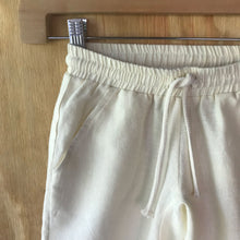 Load image into Gallery viewer, Close-up of FAUNA Kids Beige Sustainable Hemp Shorts featuring 2 front pockets, a comfortable crotch inset, a waistband with organic cotton rope to adjust to child's waist size, and lots of love to Mother Earth. 
