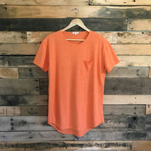 Load image into Gallery viewer, FAUNA orange hemp and organic cotton mens tee featuring a raw edged pocket, curved hem, and round neck. 
