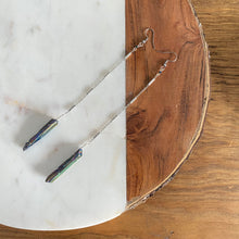 Load image into Gallery viewer, Fauna healing crystals as jewelry with these beautiful long shoulder duster earrings. Made from a stainless steel chain with a Rainbow Aura Quartz crystal at the end, connected to stainless steel french hook ear wires.
