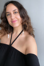 Load image into Gallery viewer, Woman wearing a Fauna organic cotton gauze blouse and healing crystals as jewelry with these beautiful long shoulder duster earrings. Made from a stainless steel chain with a White Quartz crystal at the end, connected to stainless steel french hook ear wires.
